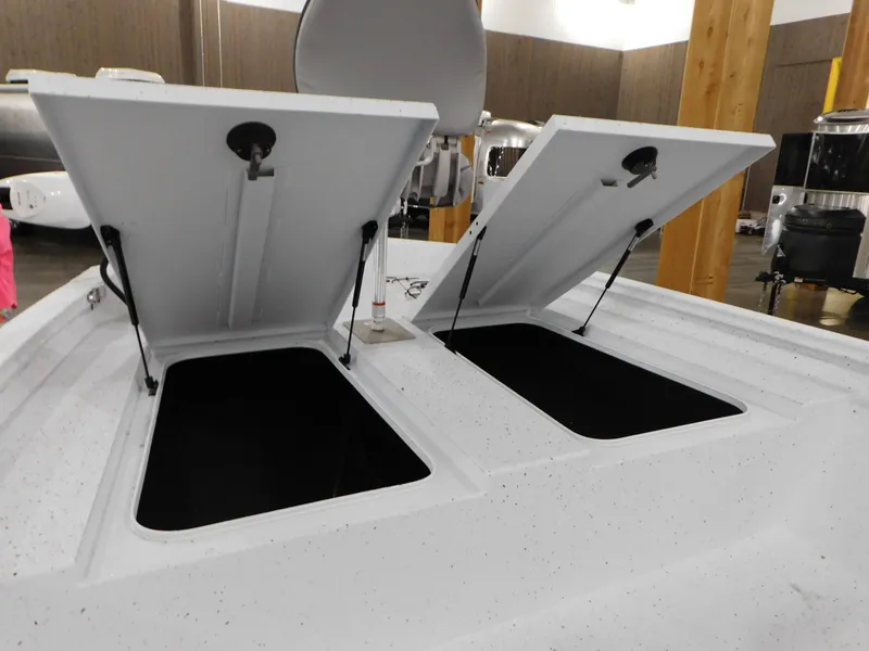 Slide: The Image of 2023 Xpress H190B boat with open storage compartments. - 27