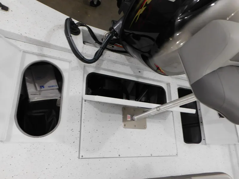Slide: The Image of 2023 Xpress H190B boat interior with storage compartments and motor. - 28