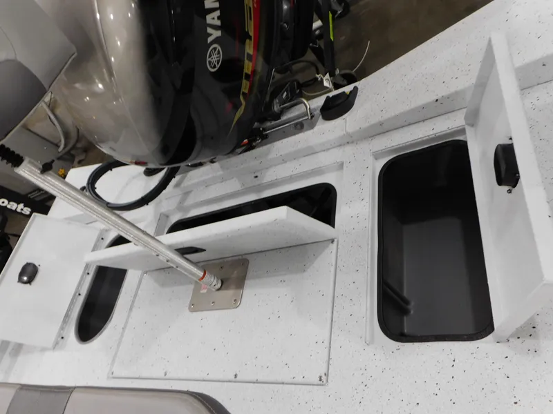 Slide: The Image of 2023 Xpress H190B boat with open storage compartments and Yamaha outboard motor. - 29