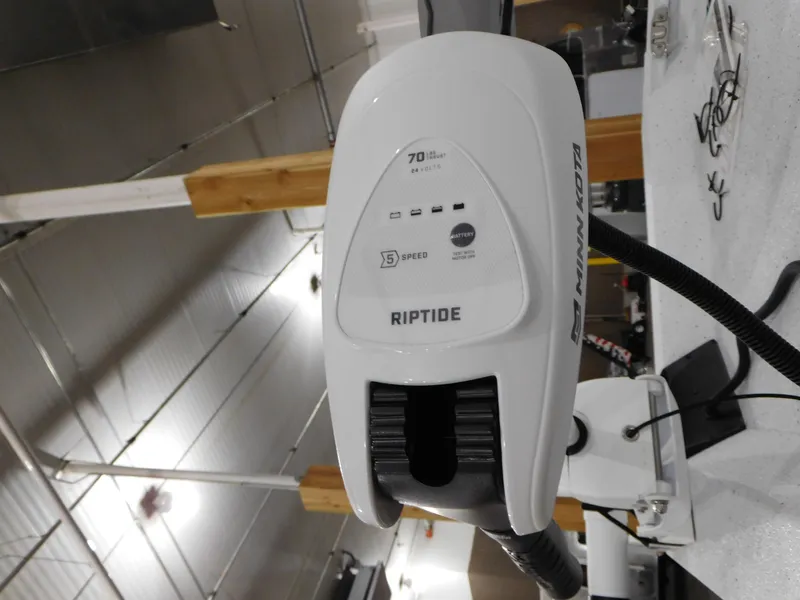 Slide: The Image of 2023 Xpress H190B boat with Minn Kota Riptide trolling motor in a workshop. - 30