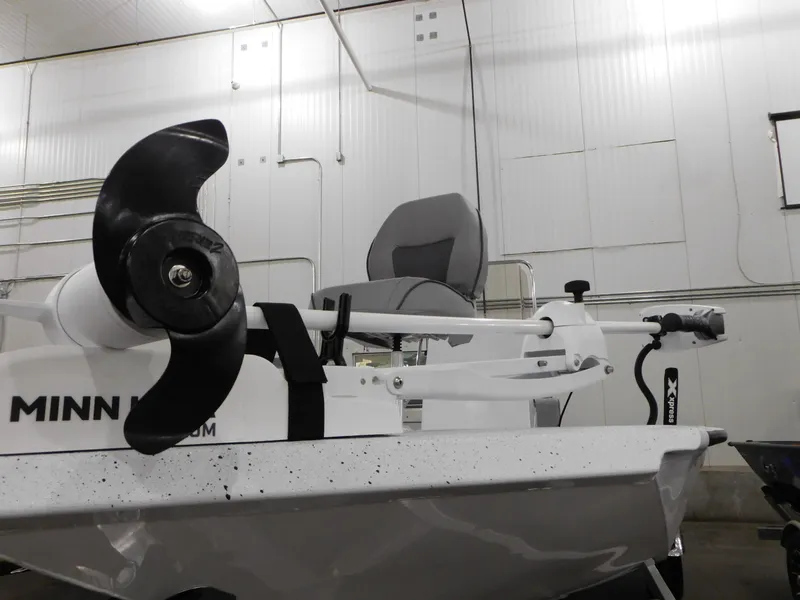 Slide: The Image of 2023 Xpress H190B boat with Minn Kota trolling motor in a warehouse. - 31