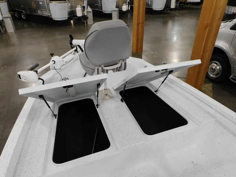Slide: The Image of 2023 Xpress H190B boat with open storage compartments and a captain's chair. - 6