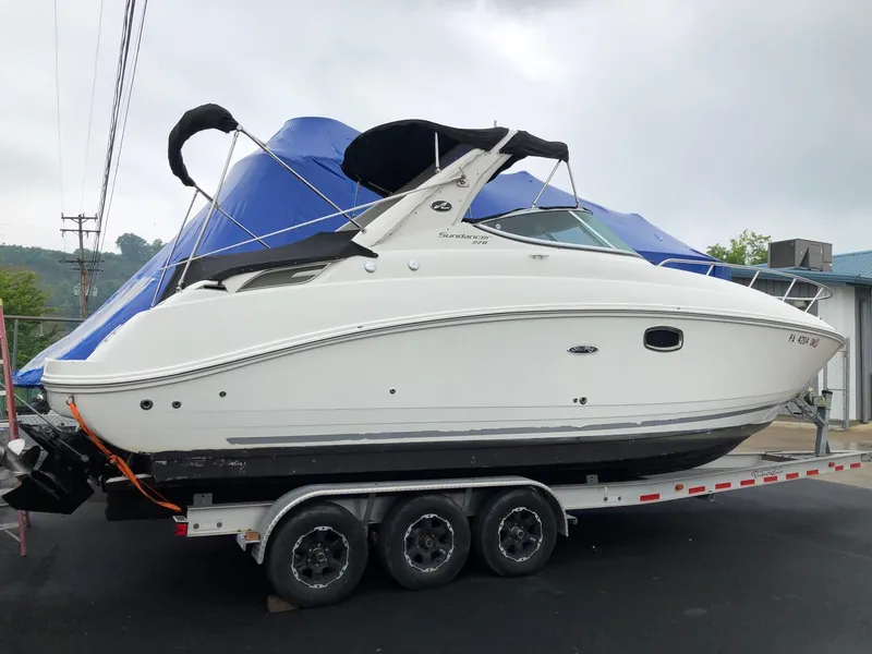 Slide: The Image of 2009 Sea Ray 270 Sundancer on a triple-axle trailer, side view. - 2