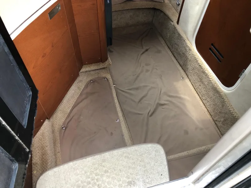Slide: The Image of Interior cabin of a 2009 Sea Ray 270 Sundancer boat with carpeted flooring. - 20