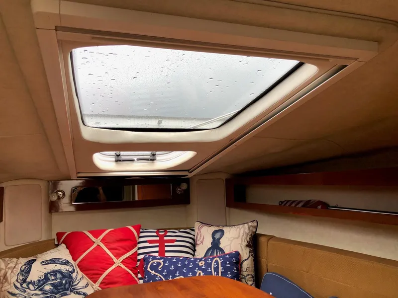 Slide: The Image of Interior cabin of 2009 Sea Ray 270 Sundancer with skylight and nautical-themed pillows. - 22