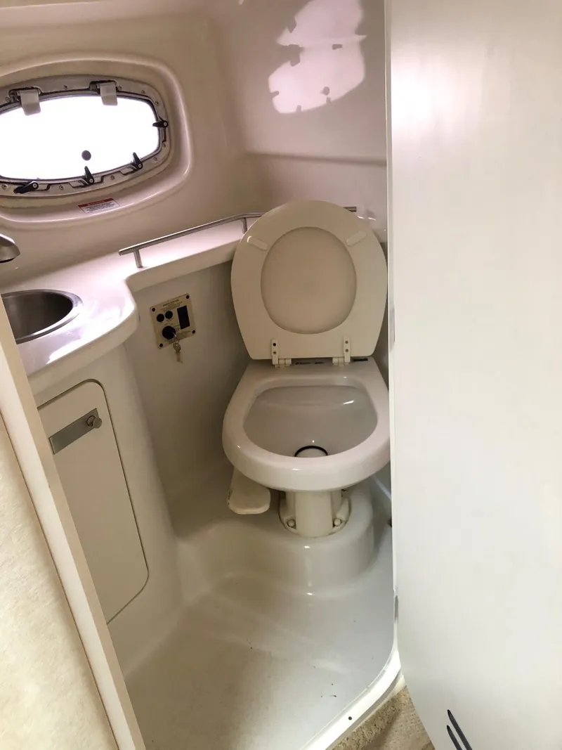 Slide: The Image of 2009 Sea Ray 270 Sundancer boat bathroom with toilet and sink. - 26