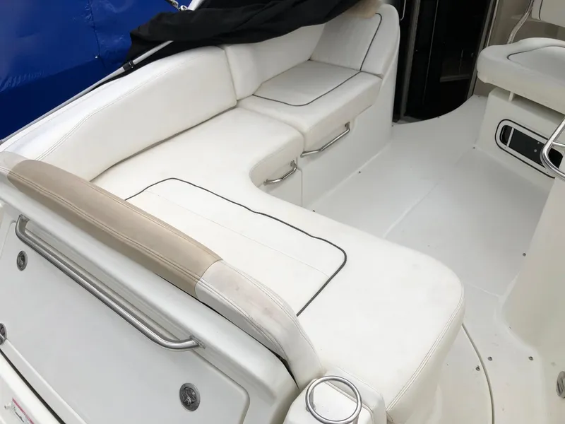 Slide: The Image of 2009 Sea Ray 270 Sundancer boat interior with white seating and clean design. - 6