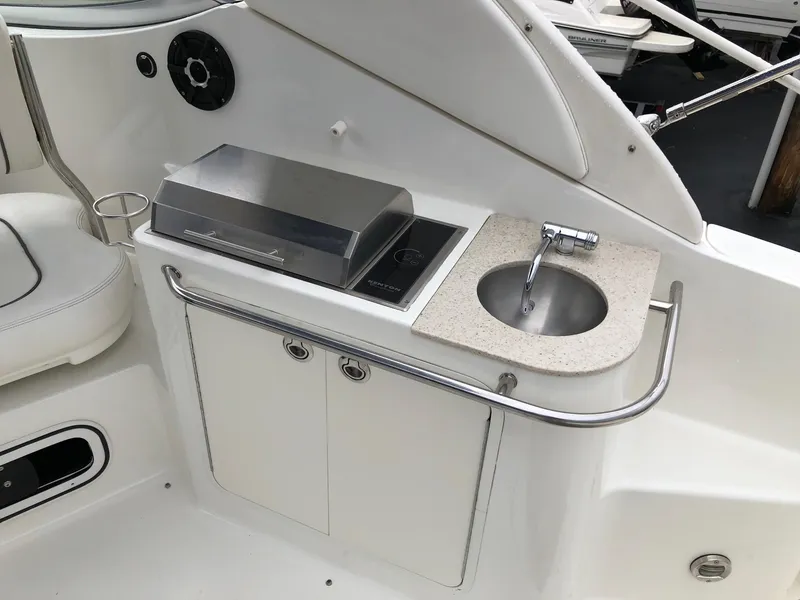 Slide: The Image of 2009 Sea Ray 270 Sundancer boat kitchenette with sink and grill. - 8