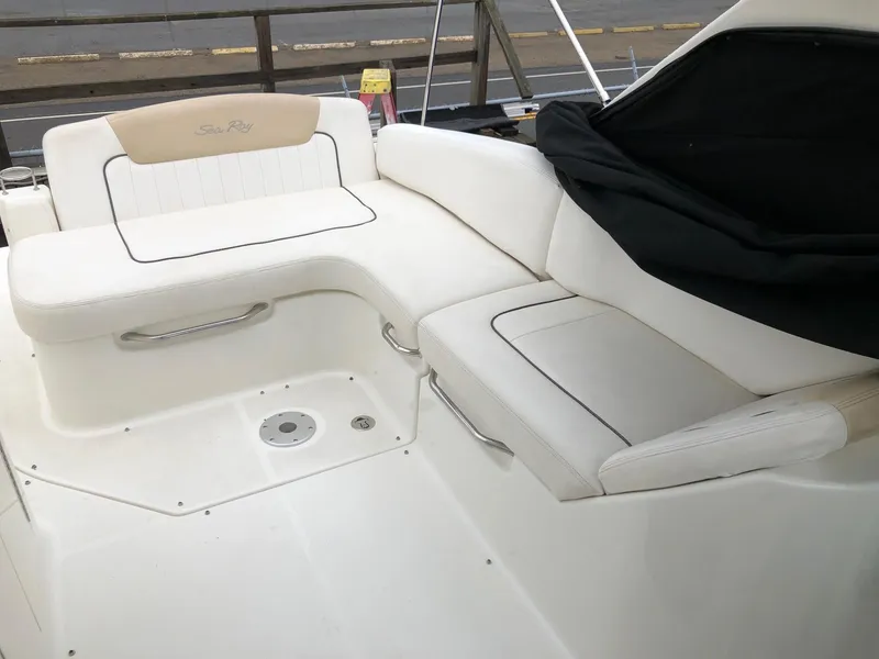 Slide: The Image of 2009 Sea Ray 270 Sundancer boat with white cushioned seating area. - 9