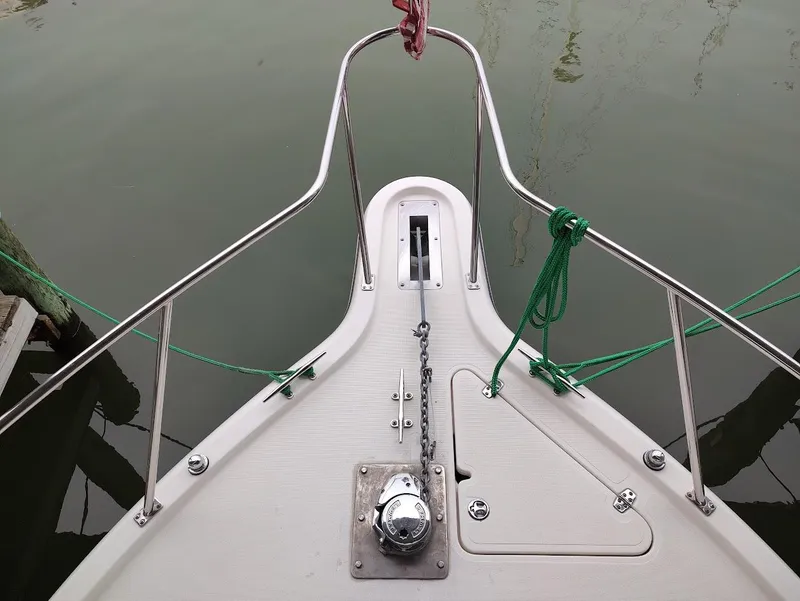 Slide: The Image of Bow of a 2002 Pursuit 3000 Express boat with anchor and railing. - 14