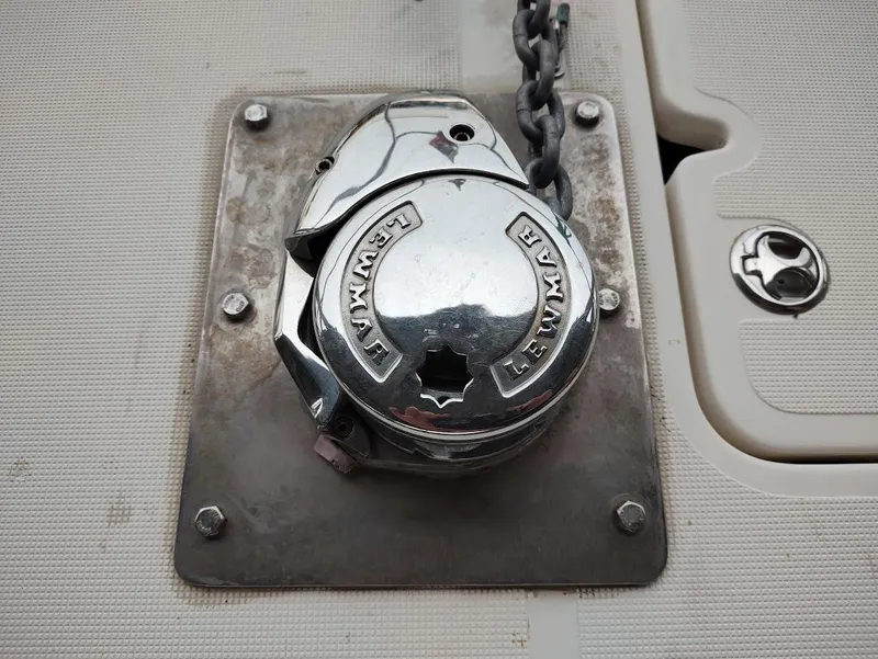 Slide: The Image of Chrome Lewmar windlass on 2002 Pursuit 3000 Express boat deck. - 15