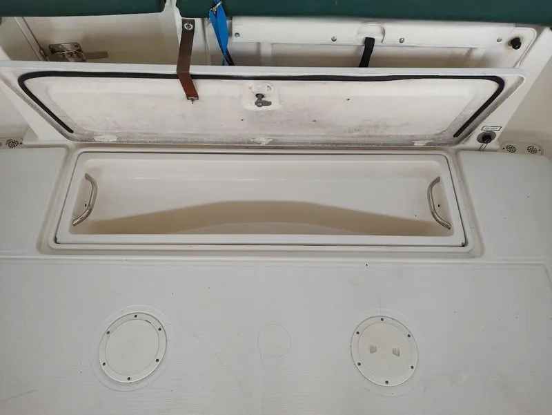 Slide: The Image of Open storage compartment on a 2002 Pursuit 3000 Express boat. - 23