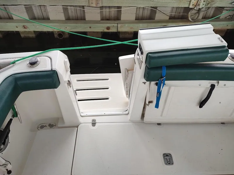 Slide: The Image of 2002 Pursuit 3000 Express boat interior with green seating and deck details. - 25