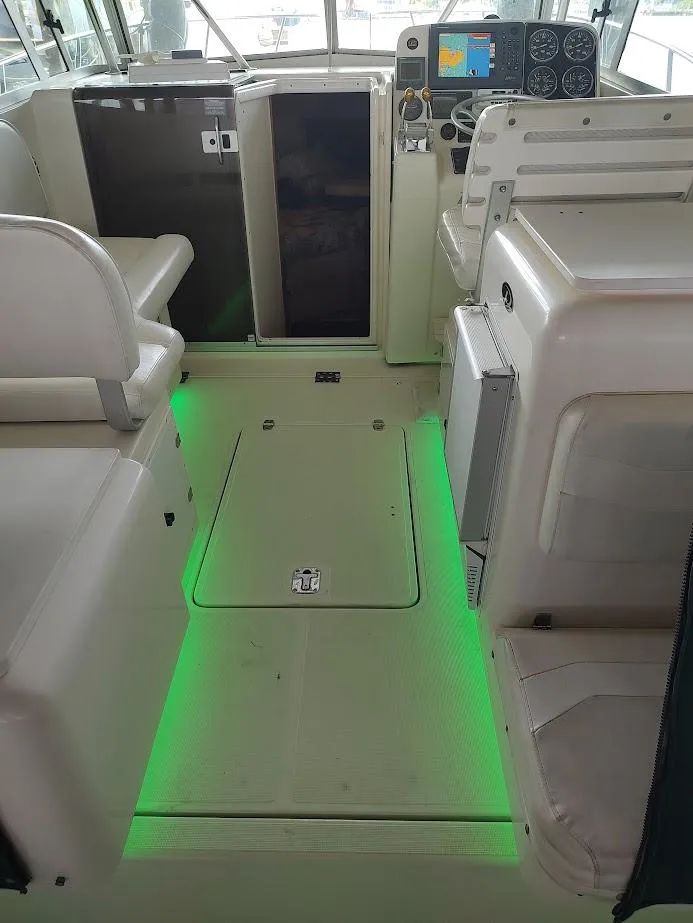 Slide: The Image of Interior of a 2002 Pursuit 3000 Express boat with green LED floor lighting. - 33