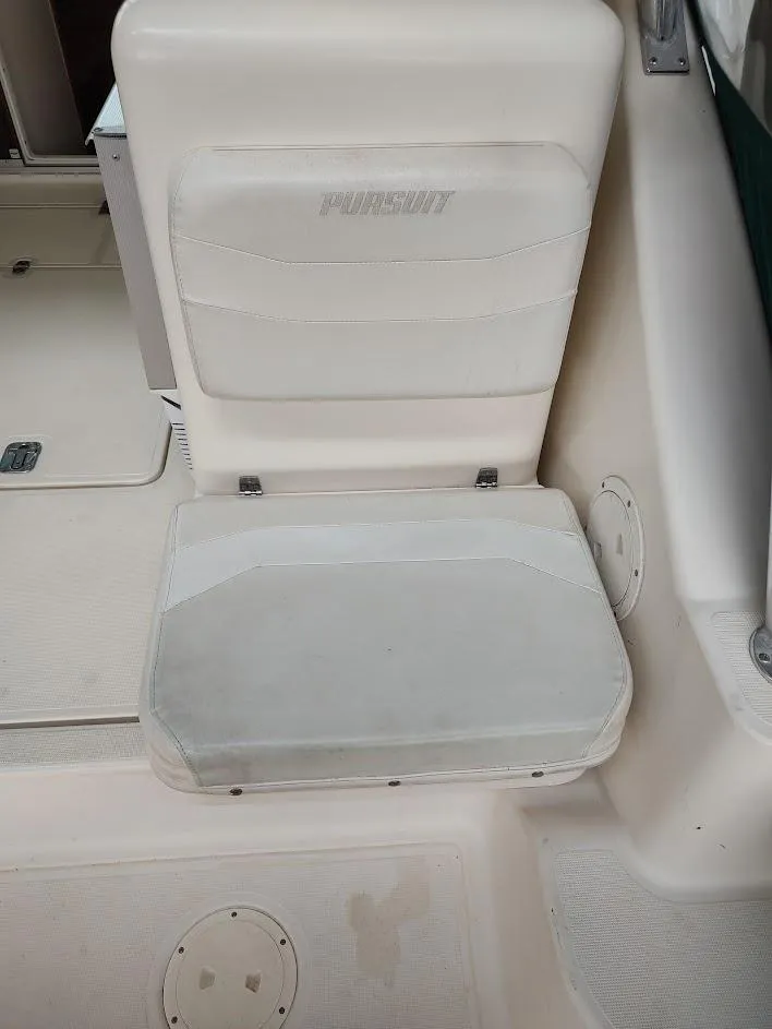 Slide: The Image of 2002 Pursuit 3000 Express boat seat, white upholstery, interior view. - 35