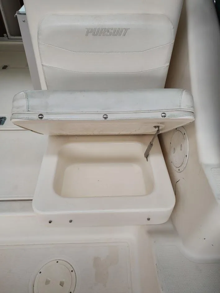 Slide: The Image of 2002 Pursuit 3000 Express boat seat with storage compartment, white upholstery. - 36