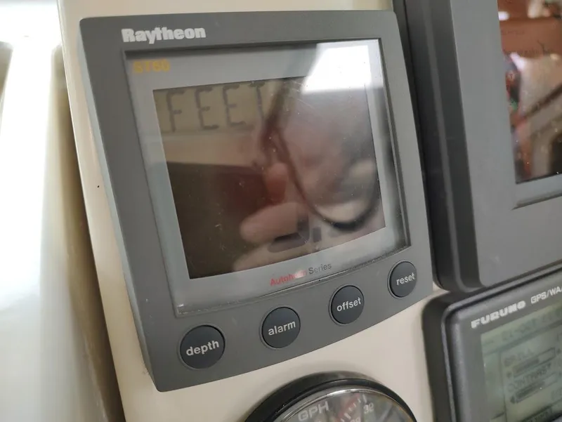 Slide: The Image of Raytheon ST60 display on 2002 Pursuit 3000 Express boat dashboard. - 46