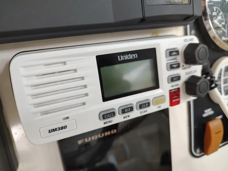 Slide: The Image of Uniden UM380 radio on 2002 Pursuit 3000 Express boat dashboard. - 48