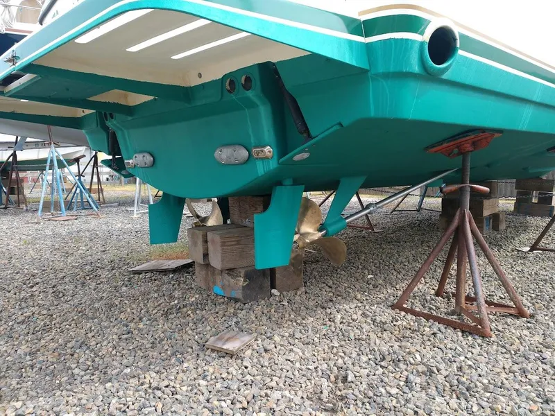 Slide: The Image of 2002 Pursuit 3000 Express boat on stands, showing propeller and hull details. - 7