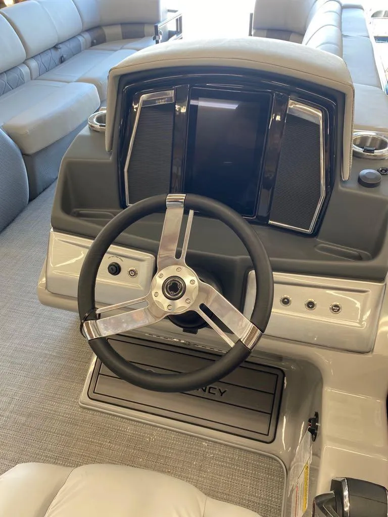 Slide: The Image of 2023 Regency 250 LE3 Sport boat dashboard and steering wheel. - 10