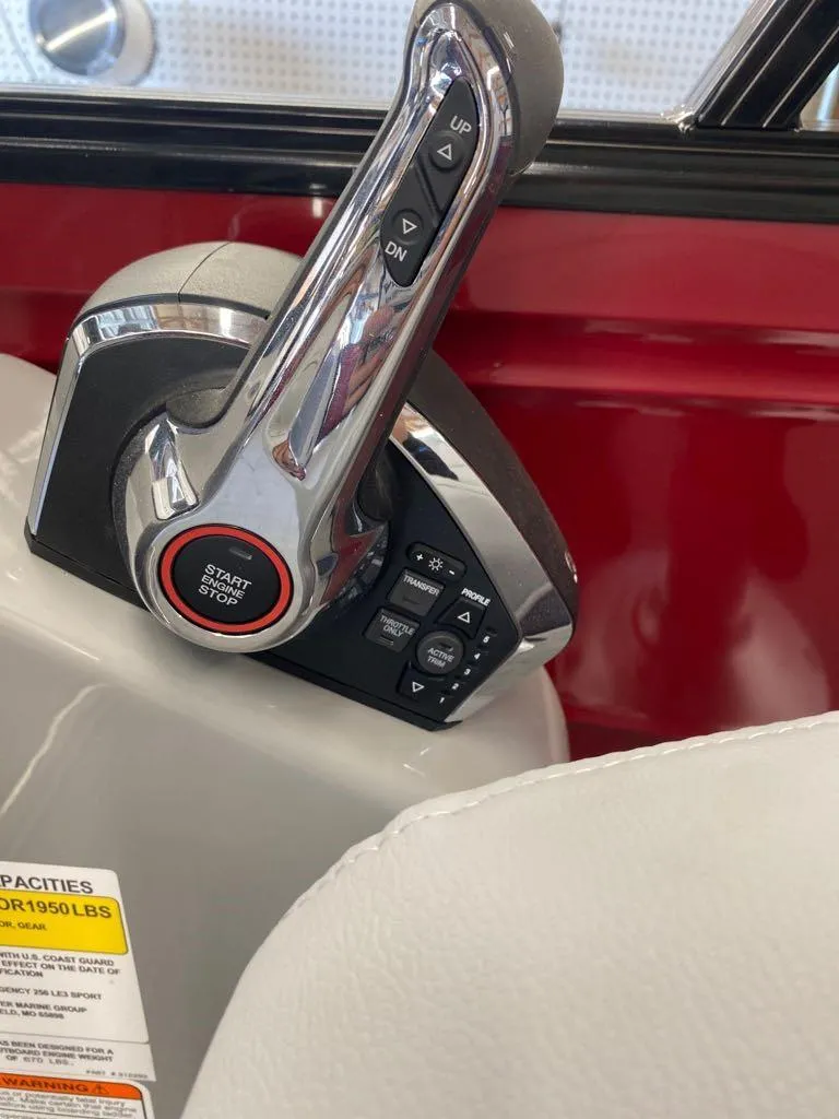 Slide: The Image of 2023 Regency 250 LE3 Sport boat throttle control and start button. - 11