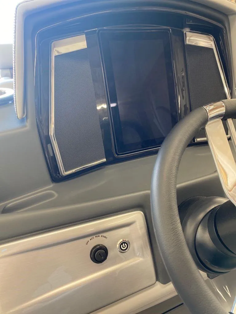 Slide: The Image of 2023 Regency 250 LE3 Sport dashboard with steering wheel and control panel. - 13