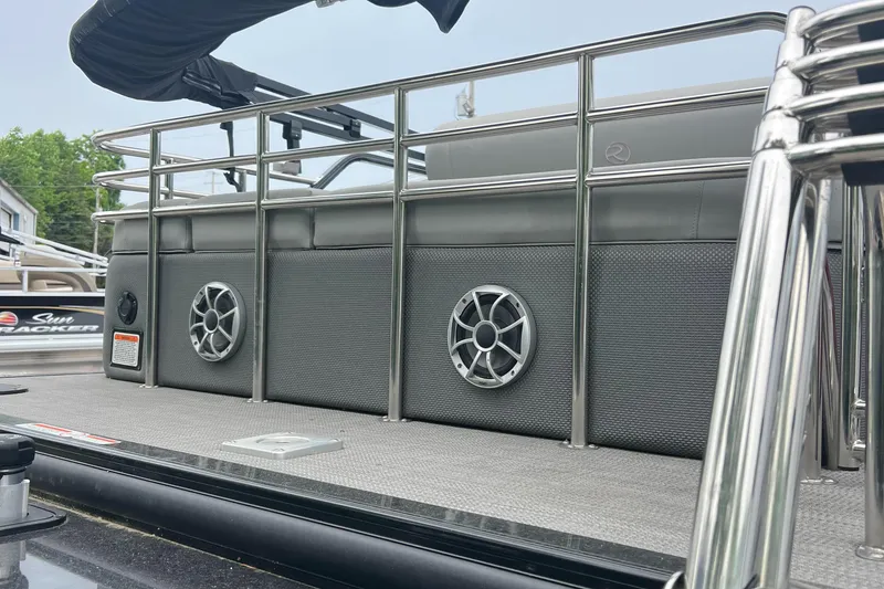 Slide: The Image of 2023 Regency 250 LE3 Sport pontoon boat with sleek railing and speakers. - 5