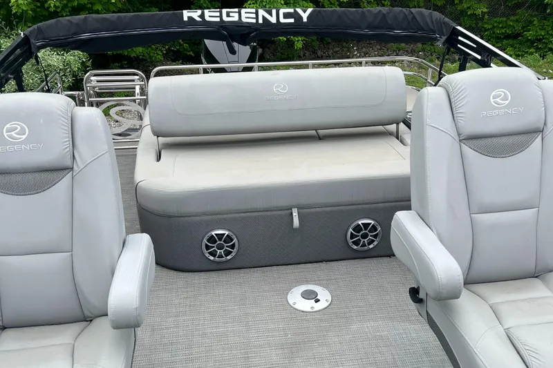 Slide: The Image of 2023 Regency 250 LE3 Sport boat interior with gray seating and speakers. - 6