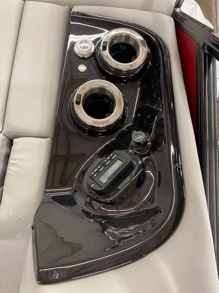 Slide: The Image of Control panel of 2023 Regency 250 LE3 Sport boat with cup holders and digital display. - 7