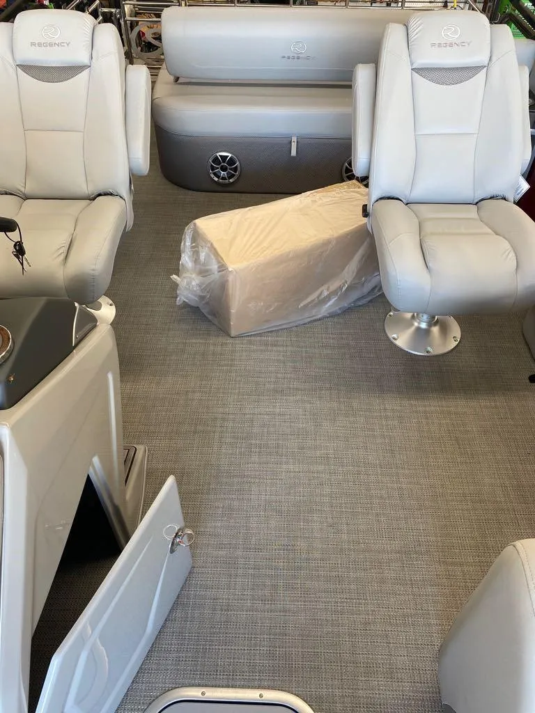 Slide: The Image of Interior of a 2023 Regency 250 LE3 Sport pontoon boat with plush seating. - 8