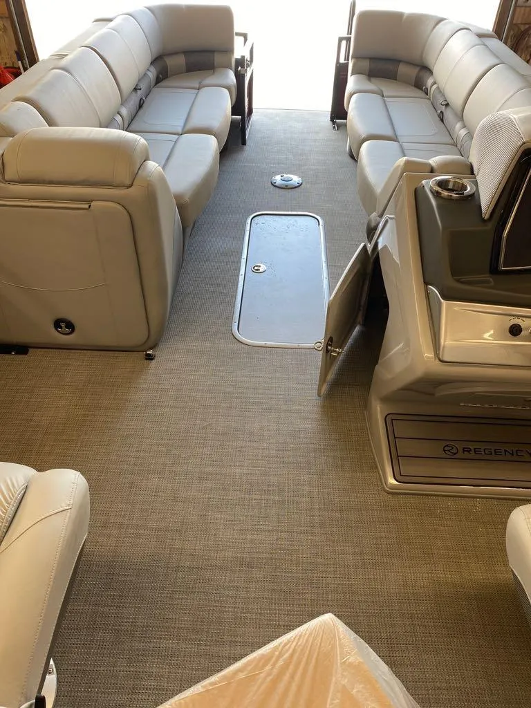 Slide: The Image of 2023 Regency 250 LE3 Sport boat interior with plush seating and modern amenities. - 9