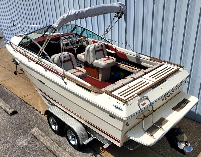 The Image of 1984 Sea Ray 225 Cuddy Cabin boat on trailer, white with red accents. - 0