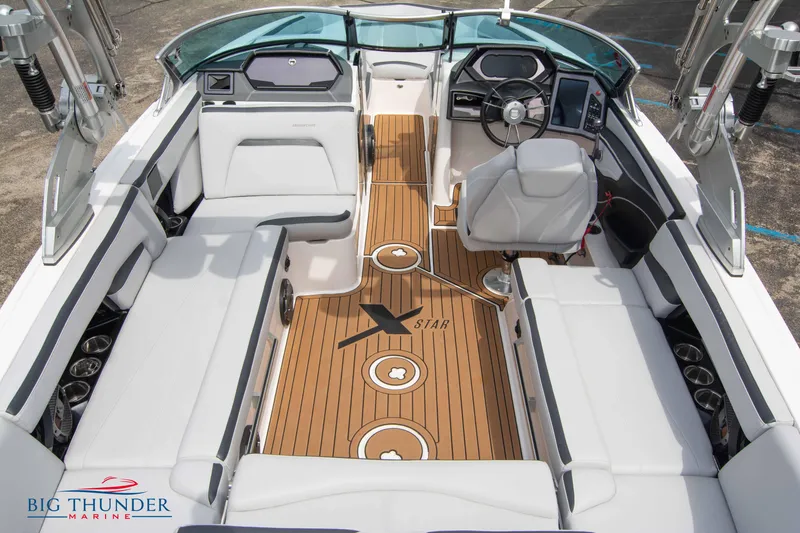 Slide: The Image of 2021 MasterCraft XStar boat interior with teak flooring and white seating. - 14