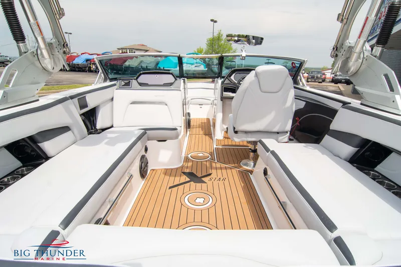 Slide: The Image of 2021 MasterCraft XStar boat interior with white seating and teak flooring. - 16