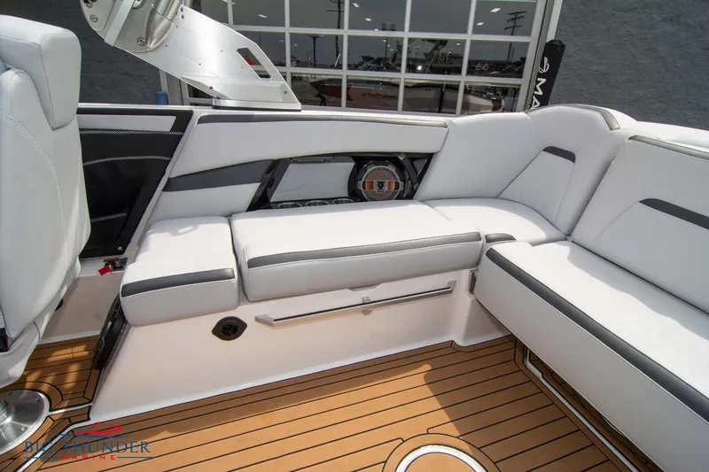 Slide: The Image of 2021 MasterCraft XStar boat interior with white and gray seating and teak flooring. - 17