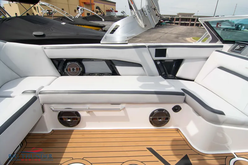 Slide: The Image of 2021 MasterCraft XStar boat interior with white seating and teak flooring. - 18