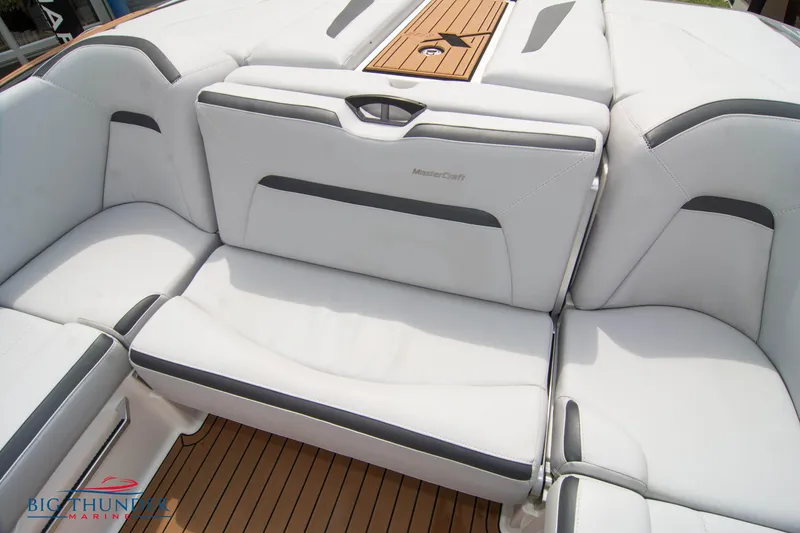 Slide: The Image of 2021 MasterCraft XStar boat interior with white leather seats and teak flooring. - 20