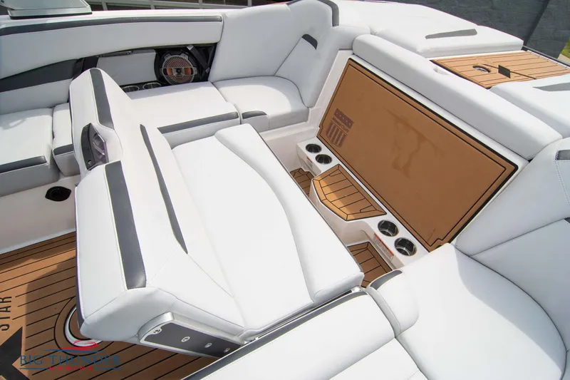 Slide: The Image of 2021 MasterCraft XStar boat interior with white leather seating and teak flooring. - 21