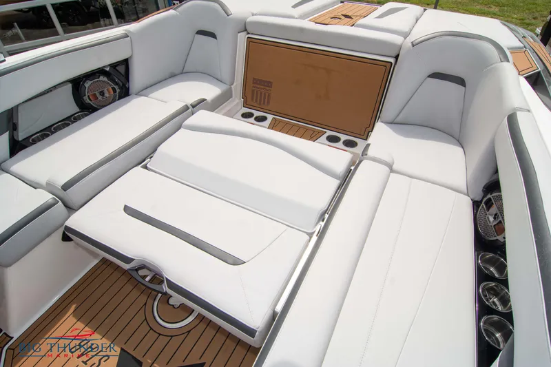 Slide: The Image of 2021 MasterCraft XStar boat interior with white cushioned seating and teak flooring. - 22