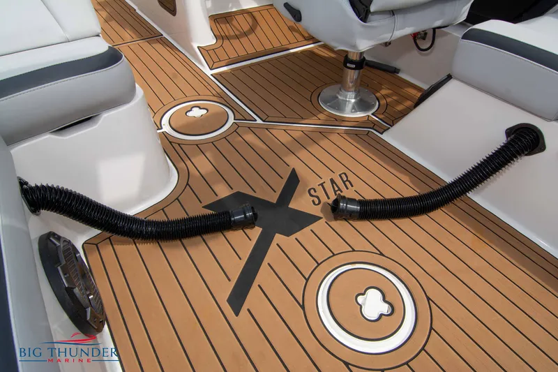 Slide: The Image of 2021 MasterCraft XStar boat interior with teak flooring and Big Thunder Marine logo. - 24