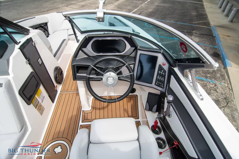 Slide: The Image of 2021 MasterCraft XStar boat cockpit with modern controls and teak flooring. - 25
