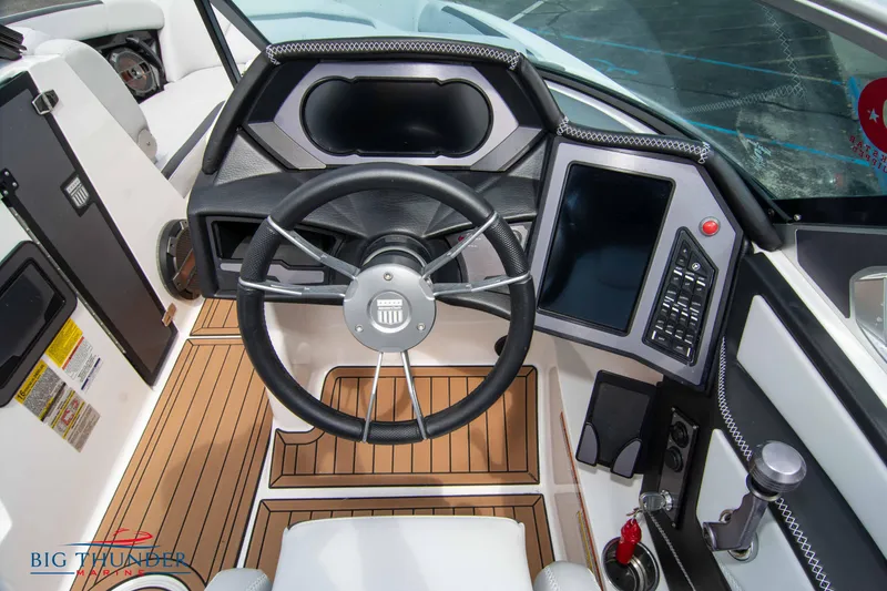 Slide: The Image of 2021 MasterCraft XStar boat cockpit with steering wheel and control panel. - 26