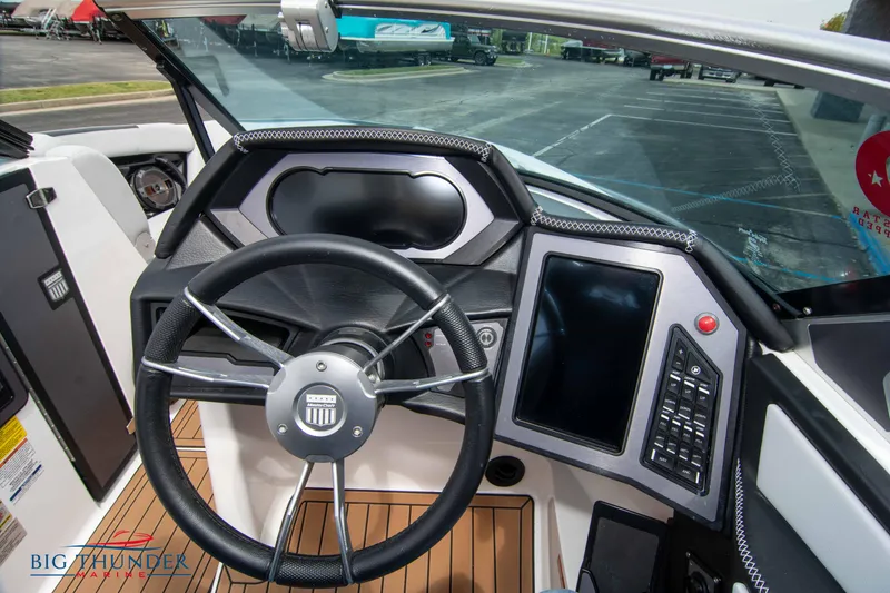 Slide: The Image of 2021 MasterCraft XStar boat dashboard with steering wheel and touchscreen display. - 27