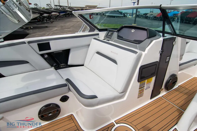 Slide: The Image of 2021 MasterCraft XStar interior with white and gray seating, teak flooring, and Big Thunder Marine logo. - 34