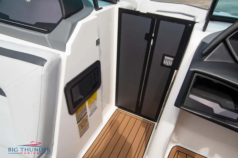 Slide: The Image of 2021 MasterCraft XStar boat interior with teak flooring and storage compartments. - 36