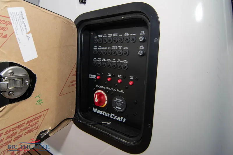 Slide: The Image of MasterCraft XStar 2021 electrical distribution panel with switches and controls. - 37
