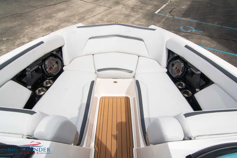 Slide: The Image of 2021 MasterCraft XStar boat interior with white seating and teak flooring. - 38