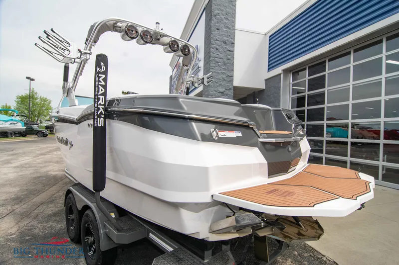 Slide: The Image of 2021 MasterCraft XStar boat on trailer outside dealership. - 5