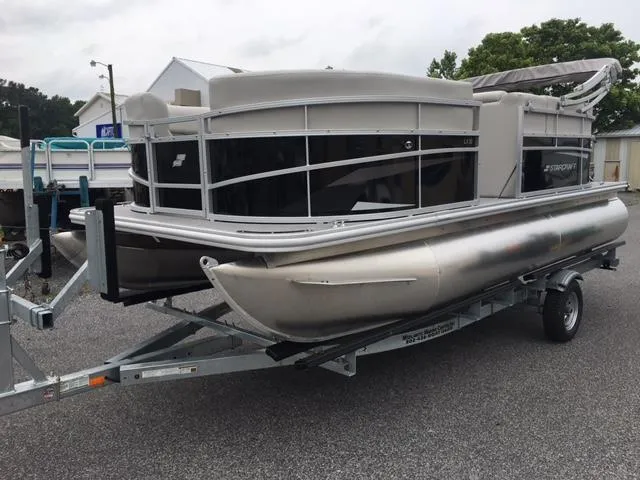 Slide: The Image of 2023 Starcraft LX 18 R pontoon boat on a trailer. - 0