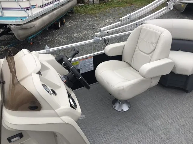 Slide: The Image of 2023 Starcraft LX 18 R boat interior with captain's chair and steering console. - 4